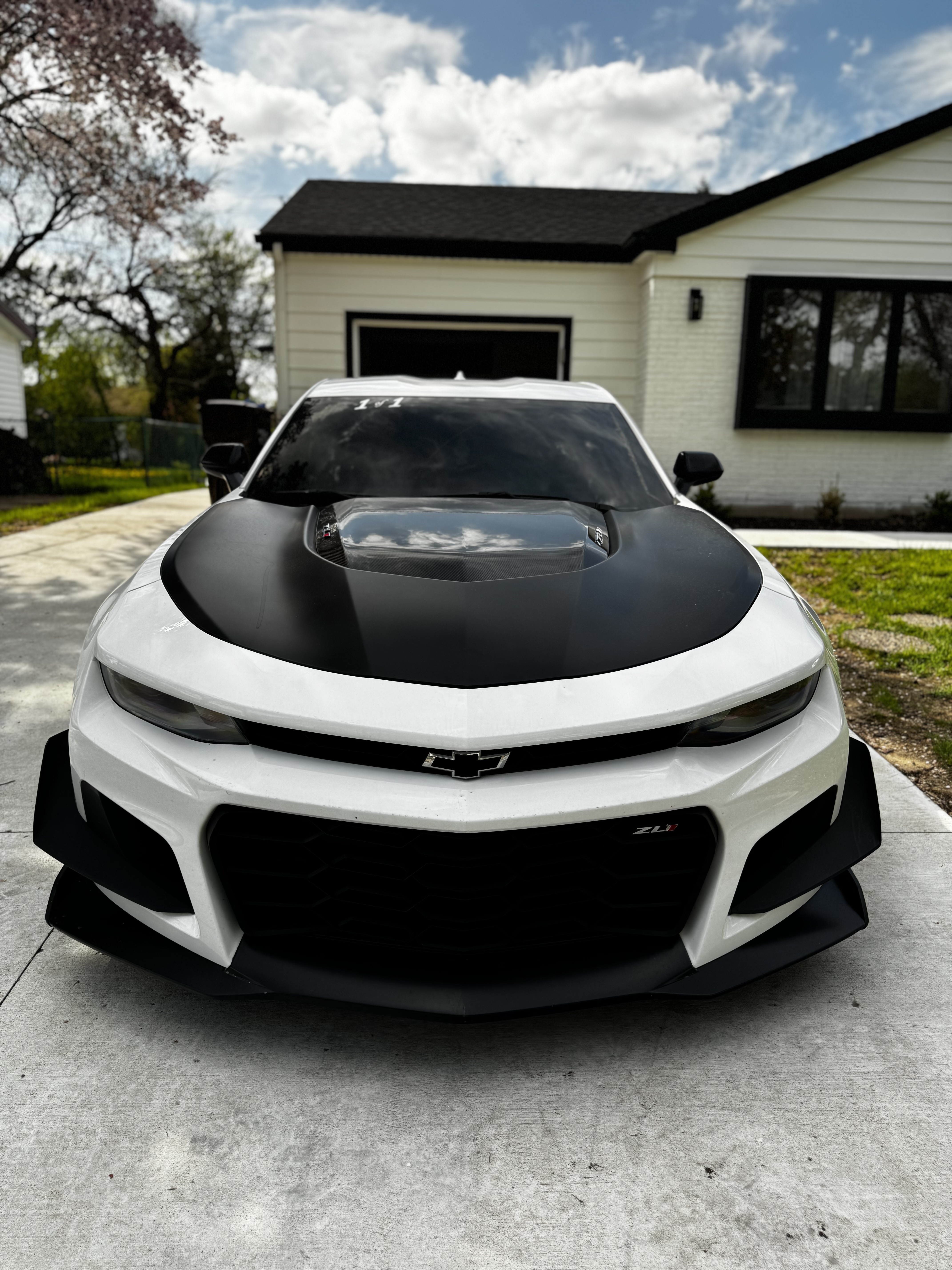 White Camaro ZL1 with tinted windows on a driveway