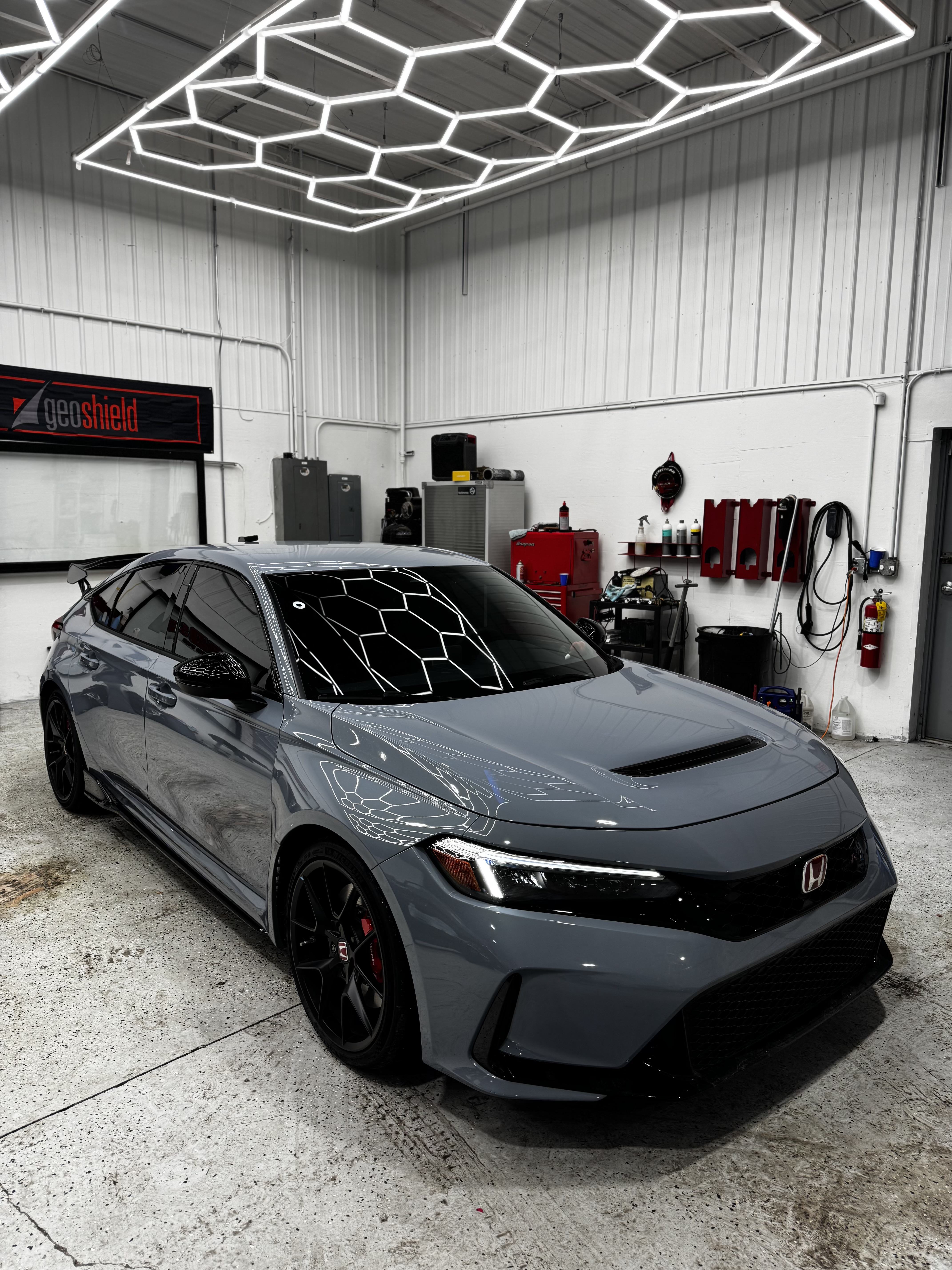 Honda Civic Type R with dark window tint under studio lights